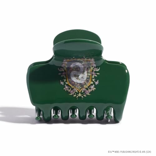 Green hair clip with Slytherin crest design.