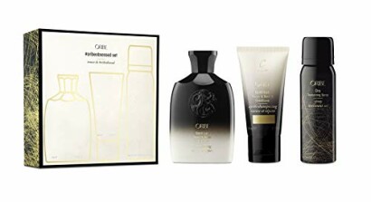 Oribe haircare styling set with three products and packaging.
